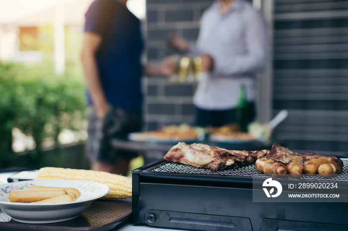 Close up grill with meat and sausage ready for socializing celebrate with friends at outsite home.