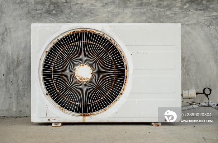 Old and worn out a condensing unit of the air conditioner at the outdoor of building