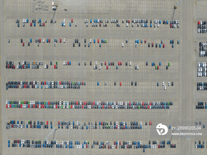 Top down aerial view of import and export car automobile storage in harbour port. Automotive industr