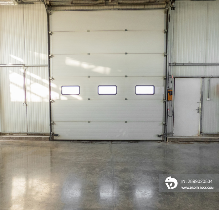 large closed gate with windows in the factory. front view