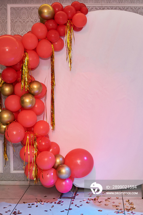 Wedding or birthday photo zone with red and gold balloons on white paper background, copy space. Hol