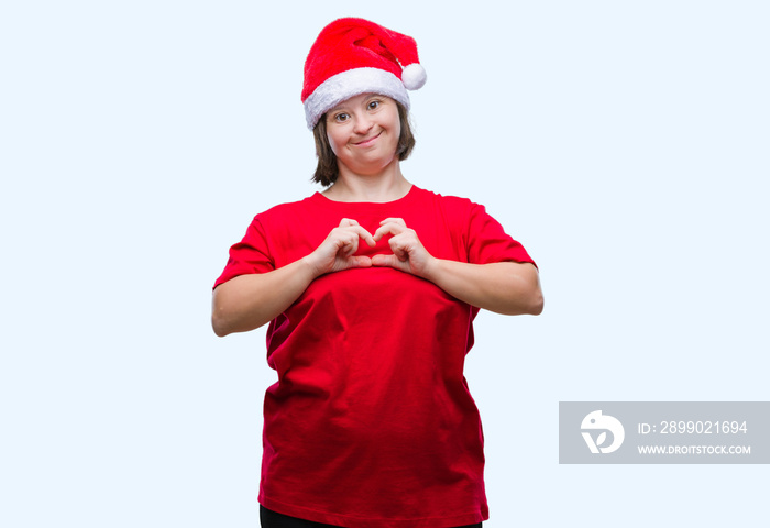 Young adult woman with down syndrome wearing christmas hat over isolated background smiling in love 