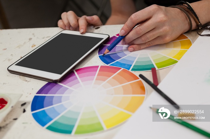 Close-up of woman matching color with color swatch