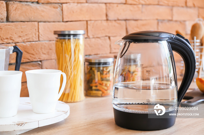 Electric kettle with water in kitchen