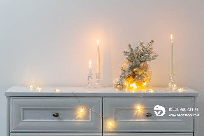 christmas decoration with burning candles in white interior