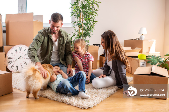 Family in their new home unpacking and playing