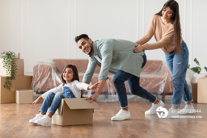 Happy arabic family celebrating moving day in new apartment