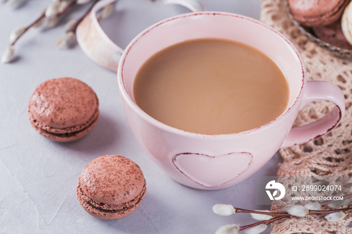 Pink coffee mug with sweet pastel french macaroons and pussy willow