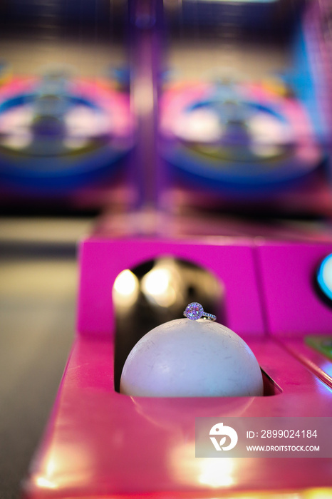 Engagement Ring Detail Shot on a Skee Ball in an Arcade