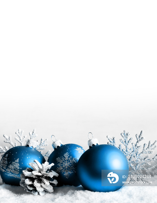 Christmas balls, snowflake and pine cone on winter background.