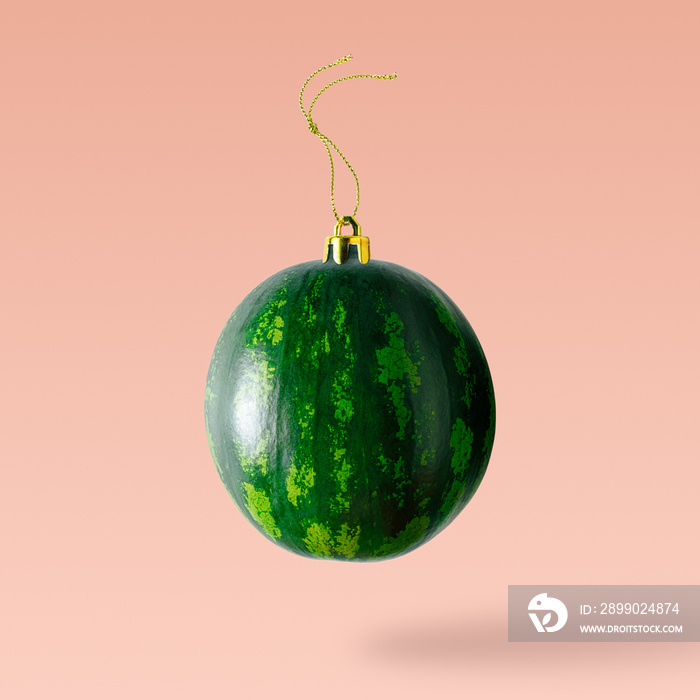 Christmas bauble decoration made of watermelon. Minimal New year concept.