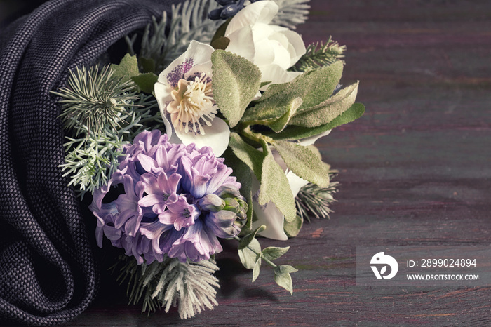 Flower bouquet in the winter style with blue hyacinth, white anemones and branches of christmas tree