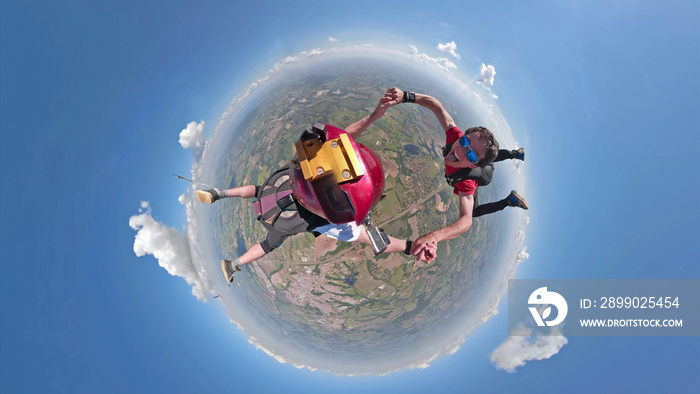 Skydivers having fun small planet view