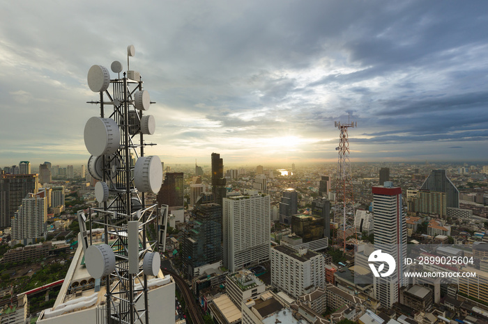 Telecommunication tower with 5G cellular network antenna on city background