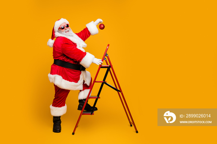 Full size profile side photo of funky funny santa claus decorate christmas tree climb stairs want ha