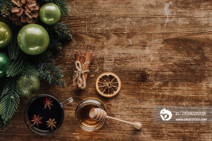 top view of mulled wine, honey and fir twigs on wooden tabletop, christmas concept