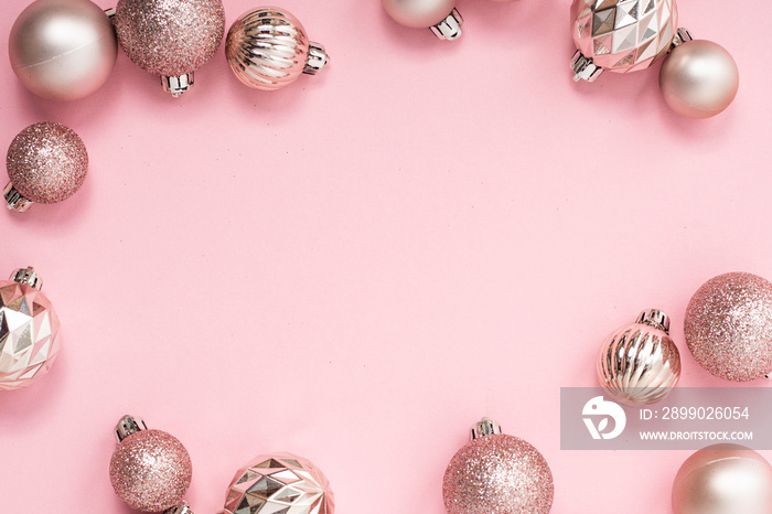 Decorative Christmas balls, empty space for text on a pink background. Top view, flat lay.