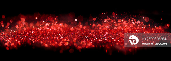 Bokeh of sparkling red lights and glitter on black