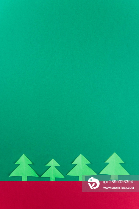 Happy new year and Merry Christmas card minimalistic concept. Handmade vertical paper tree cutting d