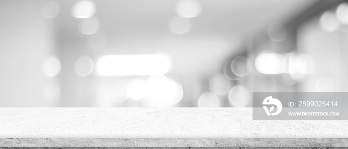 Empty white cement table over blur store background, product display montage, black and white tone, 