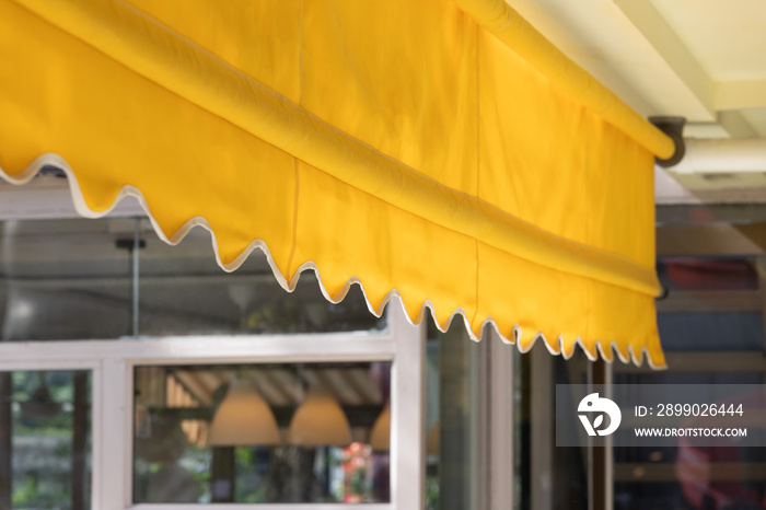 yellow blind awning of shop. canvas roof for sun protection.