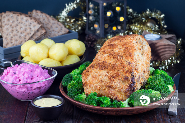 Traditional swedish and scandinavian Christmas table with baked ham in mustard crumble crust, beet s