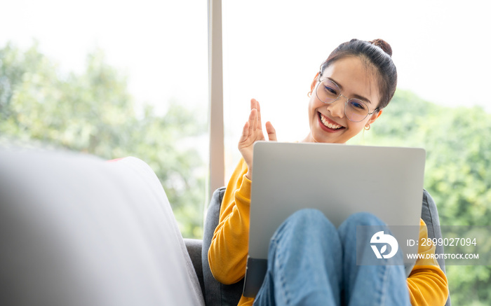 Young asian woman having conversation chatting while using laptop at house. Work at home, Video conf