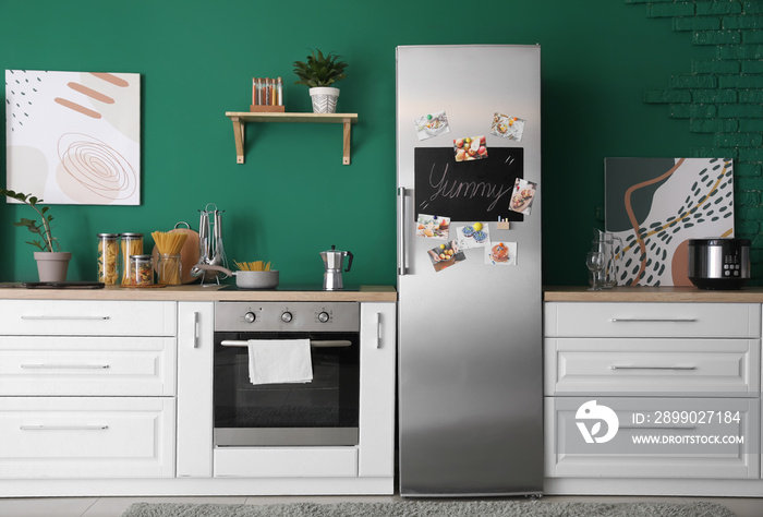 Interior of modern kitchen with refrigerator