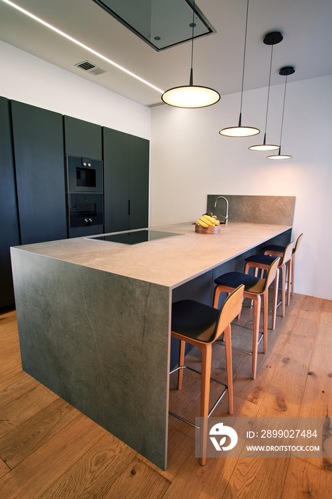 Modern kitchen with counter and chairs