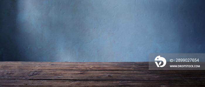 old wooden table on background dark wall