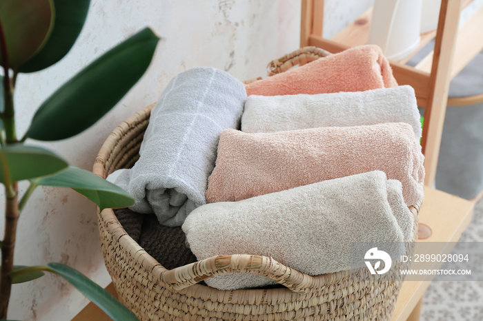 Wicker basket with clean towels in laundry room