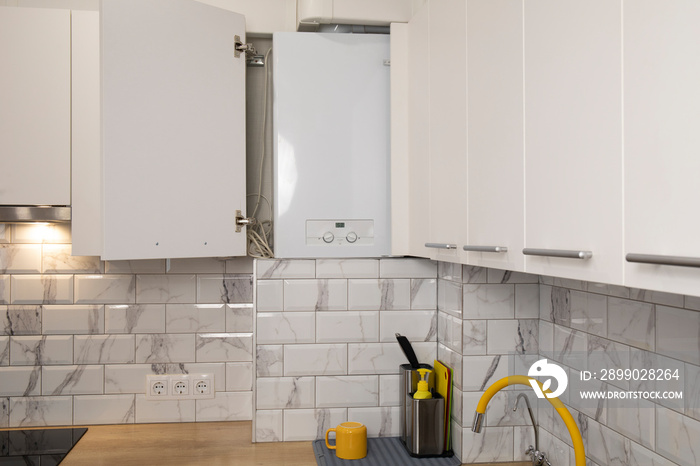 Gas boiler water heater installated in kitchen furniture