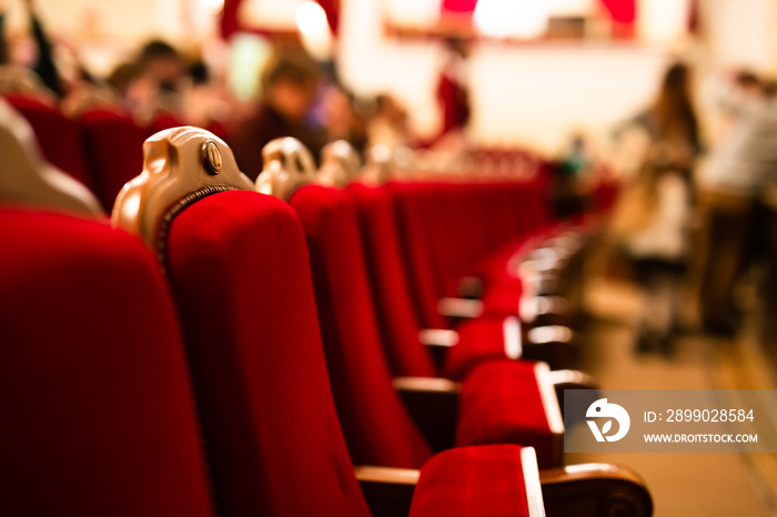 red velvet armchairs in an empty theater hall