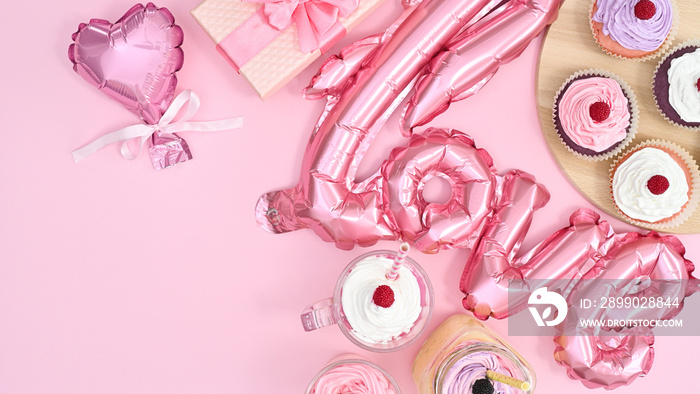 Sweet table with ballons and delicious cup cakes with cream and copy space on  pastel pink theme. Fl