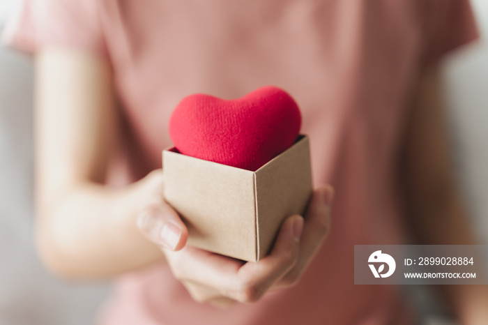 Woman holding giftbox with red heart, love, health insurance, donation, happy charity volunteer, wor