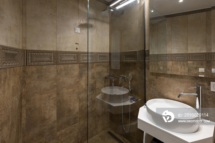 Luxury bathroom interior with glass shower wall