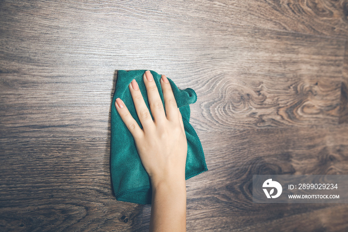 woman hand holding cloth on the wooden desk