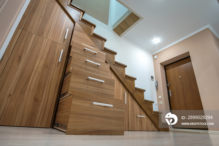 Modern architecture interior with luxury hallway with glossy wooden stairs in multi-storey house. Cu