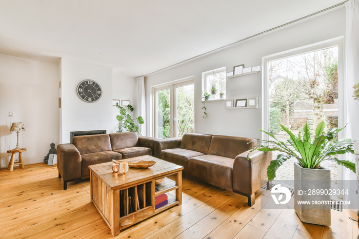 Lovely living room with leather sofa and wooden coffee table