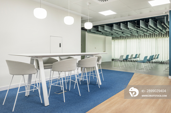 Modern white wooden dining table in coworking office with education classroom