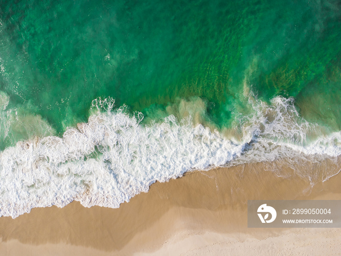 Aerial view of Barra da Tijuca Beach, a paradise in the west side of Rio de Janeiro, Brazil. Greenish sea waves and sand. Top view. Sunny day at dawn. Drone Photo