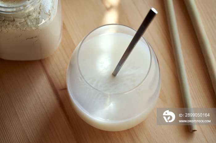 Whey protein powder mixed with water - a healthy protein drink, with bamboo straws