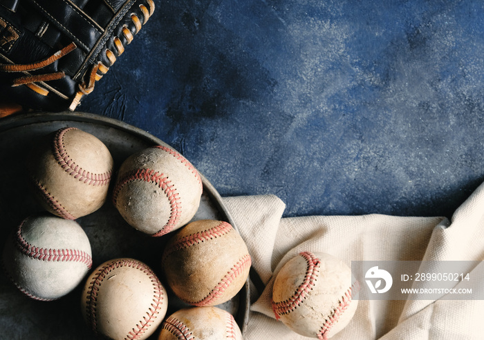 Game of baseball background with old baseballs and glove.