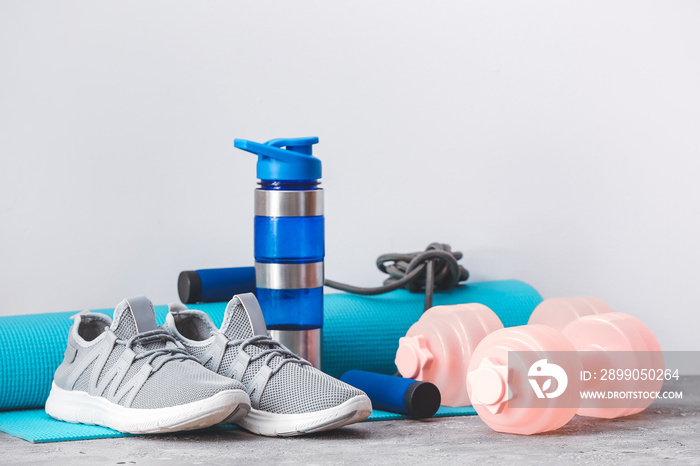 Sports equipment near light wall