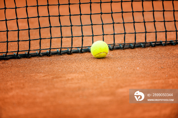 Close up of a tennis court net with tennis ball..