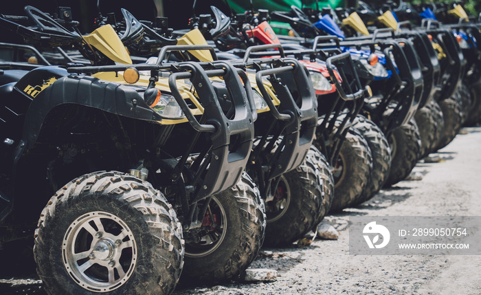 View of row dirty ATVs quad bike