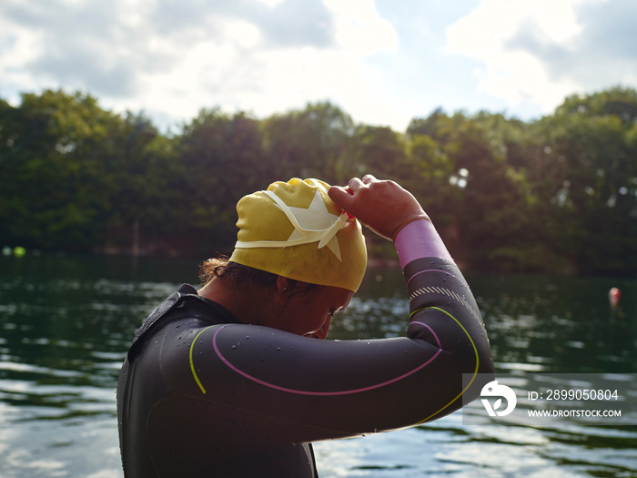 Woman taking off swimming goggles