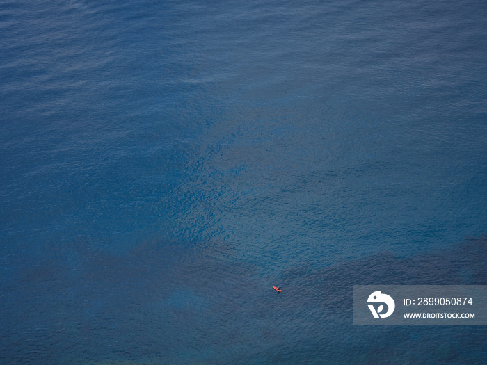 Miniature people with paddle boat in a water