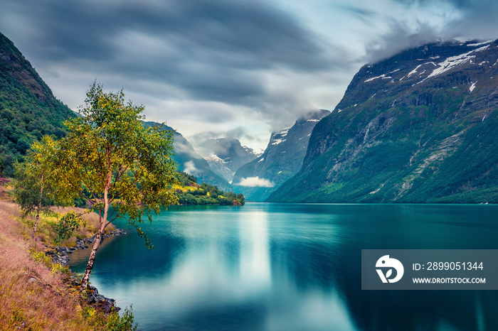 Gloomy summer view of Lovatnet lake, municipality of Stryn, Sogn og Fjordane county, Norway. Dramatic morning scene of Norway. Beauty of nature concept background.