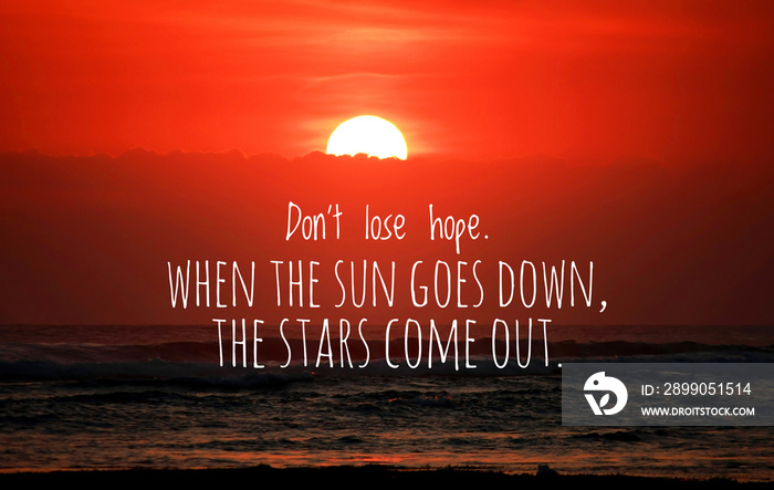 Inspirational quote - Do not lose hope. When the sun goes down, the stars come out. With blurry sunset background over the sea horizon. Half of the sun behind the clouds. Words of wisdom concept.